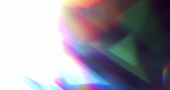 Real rainbow of light leaks through prism creating a colorful transition. Lens flares through glass in vivid chromatic aberration. Optical effect of light rays in a brilliant spectrum of colors.