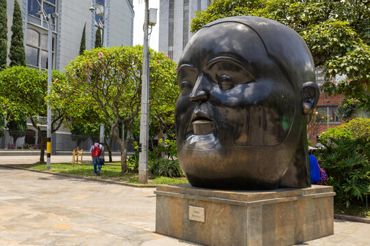 Medellin, colombia april 12, 2026, botero square botero sculpture of a large human head in public park