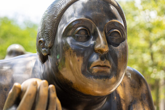 Medellin, colombia april 12, 2026, botero square bronze sculpture depicting human figure with rounded form
