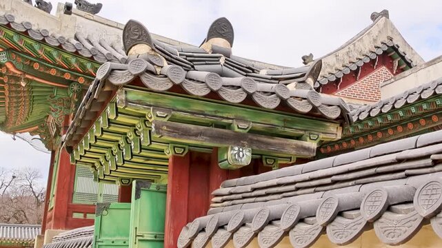 Quiet study of curved ridge and tile details beneath overcast sky