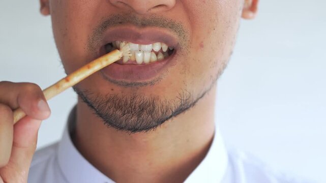 Man using miswak for traditional oral hygiene