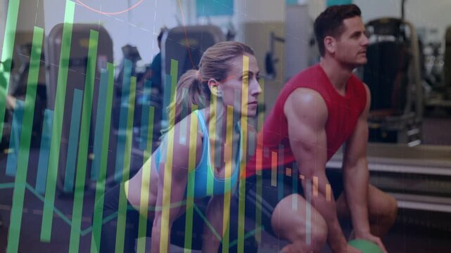 Gym duo starting moving into frame, syncing squatting with green medball, color bar over left frame