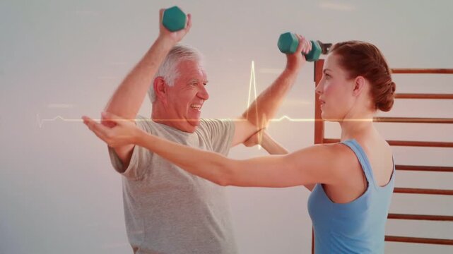 PT showing and guiding senior client doing shoulder presses for rehab, green dumbbells, EKG running
