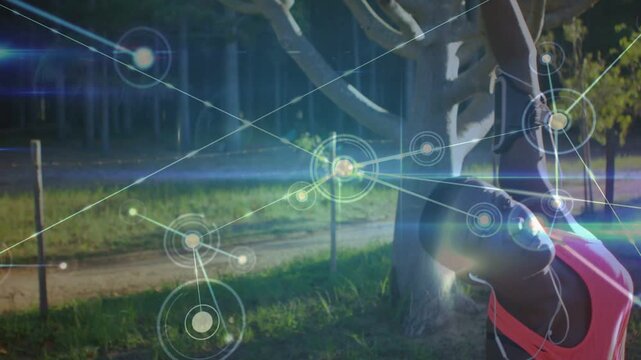 Woman performing deep backbend by tree, arching and initiating animated nodes spreading for health