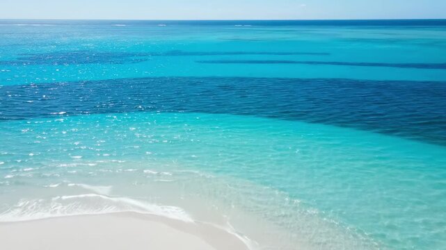 Aerial panorama of a curved white sandbar in pristine turquoise water, featuring transparent lagoon rings, clean tropical gradients, and a flawless horizon over an untouched island beach setting