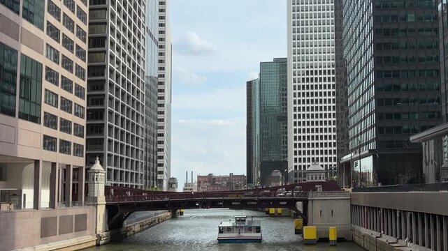 Boat Cruising Along Chicago River with Monroe Street Bridge and Downtown Skyscrapers