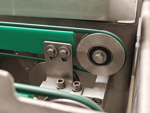 Tensioner pulley for a belt drive on a conveyor.