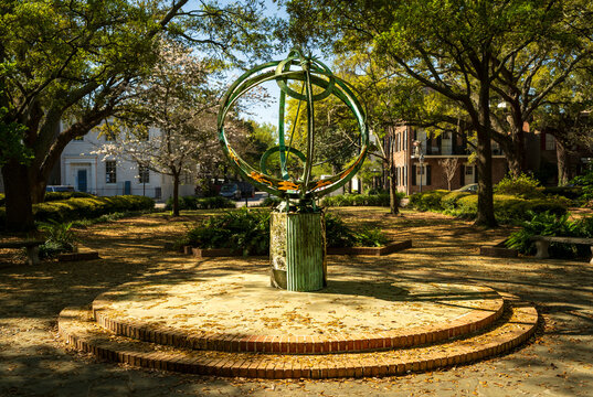 Savannah, GA - US - Mar 23, 2026 The armillary sphere in Troup Square, Savannah, is a bronze astronomical model set amidst ancient oaks, symbolizing the intersection of history, art, and science.