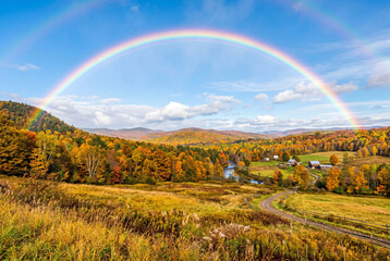 Fototapeta premium Beautiful double rainbow over an autumn valley landscape