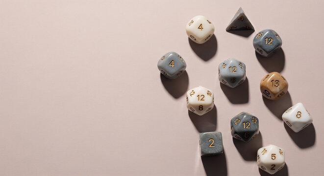 A collection of 12 sided dice featuring various colors and textures arranged on a light background for tabletop gaming and roleplaying game accessories