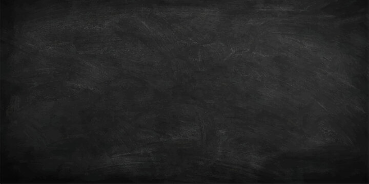 An empty vintage chalkboard with a piece of chalk sits against a dark grunge wall to create a textured and aged surface backdrop for your creative design