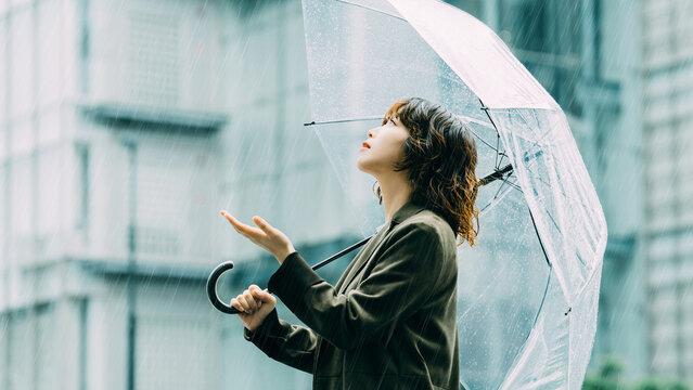 雨の日に傘をさす日本人女性・ビジネスウーマンのイメージ, Japanese Businesswoman with Umbrella on Rainy Day