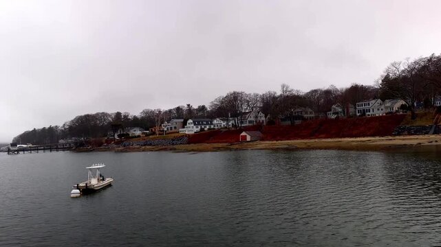 Homes on water wit rock wall in Casco Bay Falmouth, Maine