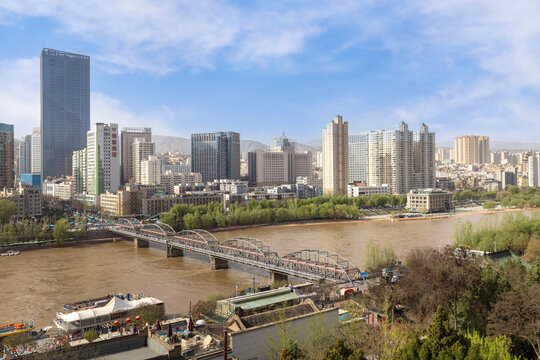 The stunning panoramic city skyline of Lanzhou reveals a breathtaking urban landscape under clear blue skies