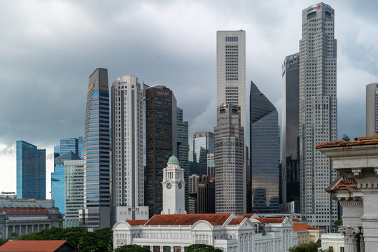 Modern Skyscrapers and Historic Clock Tower in Singapore Financial District Skyline