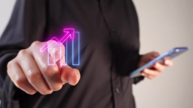 Increased sales and performance. A businesswoman holding a smartphone while pointing forward at a virtual bar graph icon with an upward-pointing arrow.