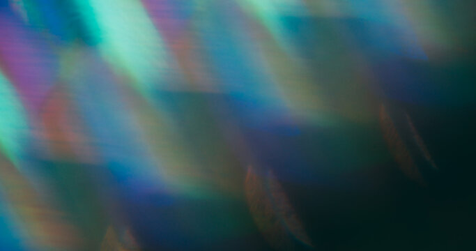 Blur flash leak. Lens prism. Colorful striped holographic light on dark background. Blue green purple luminosity abstract texture.
