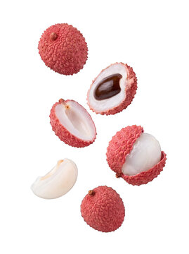 Delicious juicy lychee fruits displayed with their distinctive red skin and translucent white pulp isolated.