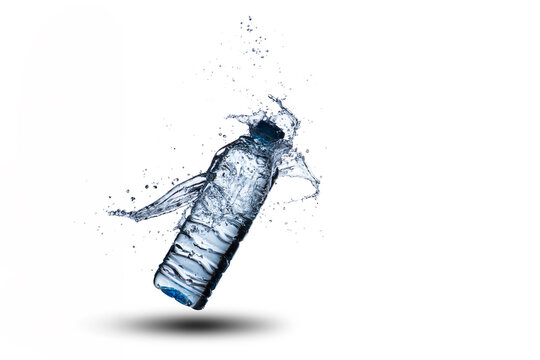 Exploding Plastic Water Bottle with Dynamic Splash Isolated on White Background