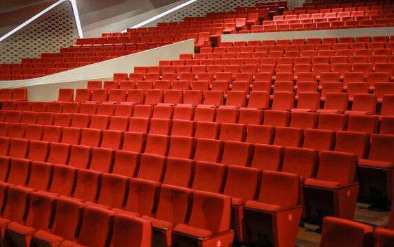 Red empty seats in the theater auditorium