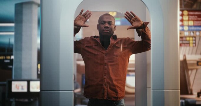 African American Male Passenger Passing Through High Tech Body Scan. Integration Technology in International Travel Safety and Routine Experience of Modern Passenger. Reliability, Public Safety.