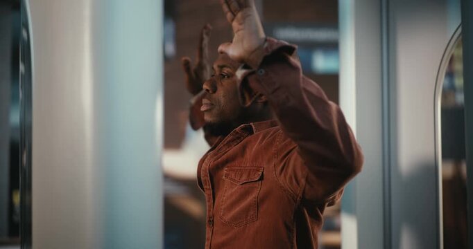 African American Man Passes Through In Circular Body Scanner at Departure Hall. Travel Guidelines, Safety Standards, and Procedural Side of Air Travel. Advanced Technology in Modern Transport Hub.