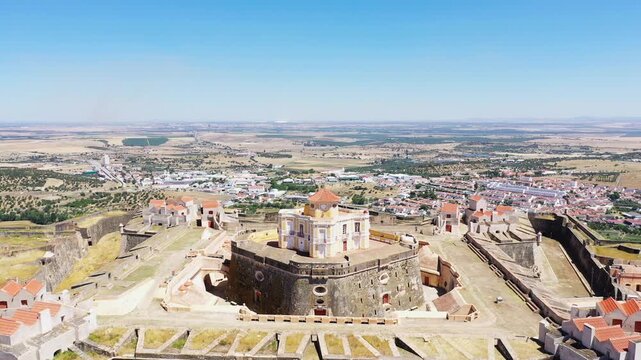 Aerial view of Forte de Nossa Senhora da Graca, a historic fortress near Elvas, Portugal, with the surrounding countryside visible under a clear blue sky.