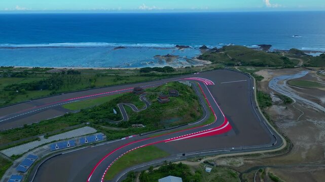 Mandalika racing track Street Circuit ocean beach. Smooth aerial view drone