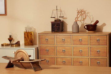 Traditional herbal medicine interior showing wooden drawers, grinding tool, and dried medicinal...
