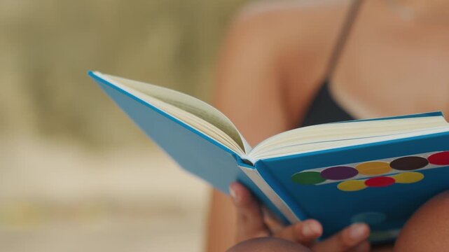 Black woman journaling blue notebook beach, hands holding pages, focused writer energy, pen marks, seaside background, sunlit skin, casual bikini straps, travel diary vibe, contemplative atmosphere