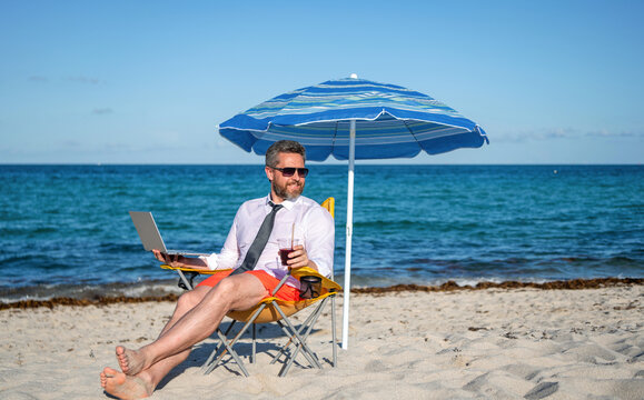 Online freelance work. Businessman office worker with laptop. Business man laptop in beach. Travel and business. Man freelance worker online at sea beach. Businessman on summer. Vacation work setup