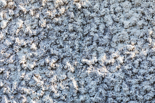 rough textured grey concrete wall with bumpy plaster surface