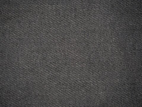 Dark gray woven fabric texture background with repeating diagonal pattern, close-up macro textile surface, subtle lighting and fine details for design backdrop.