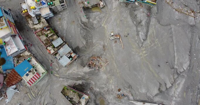 Top-down aerial view reveals the devastating impact of the Melamchi flood in Sindhupalchowk Nepal, with layers of silt burying houses and infrastructure in a remote mountain community.