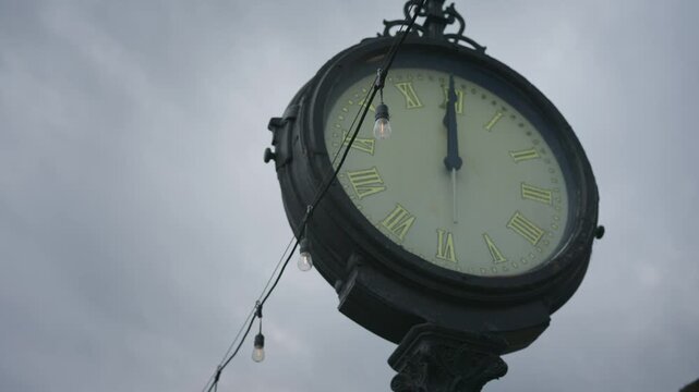 Downtown Clarkston Michigan village clock landmark in a small town setting during daylight with steady cinematic motion