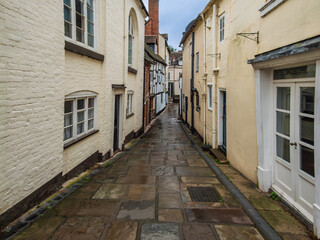 Fototapeta premium Ancient Narrow Flagstones Alley In The Rain