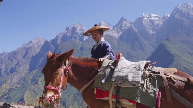 4K Cinematic Footage of Traditional Chinese Swordsman Journey Through Rugged Mountain Terrain,Ancient Chinese Martial Artist Traveling Through Snow-Capped Mountain Trails on Horse, Epic Wuxia Adventur