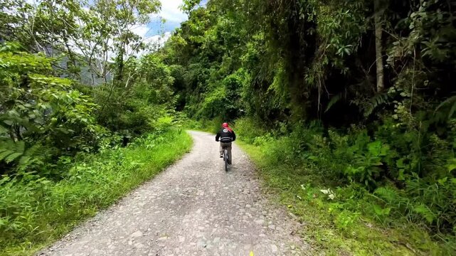 Cyclist Riding Down the North Yungas Road (Death Road) in the Bolivian Andes