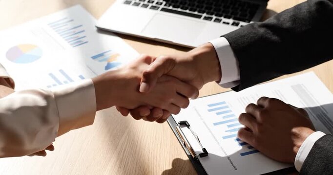 Professional business partners shake hands to finalize a contract agreement