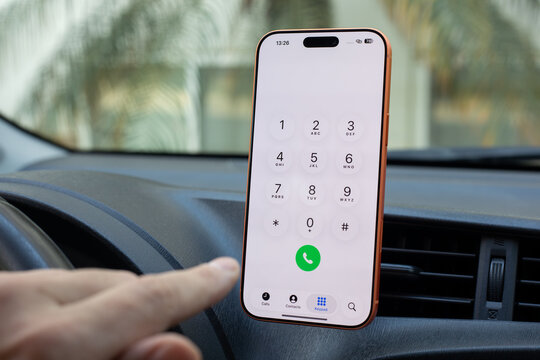 Male driver hand Phone Apple iPhone 17 Pro Max Cosmic Orange with home screen Call Phone number background Car Play