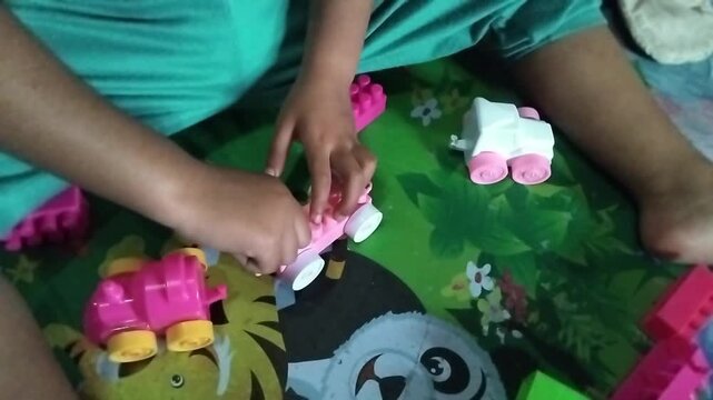 Close-up of a child playing puzzle on a colorful playmat, focusing on learning, creativity, and early childhood development