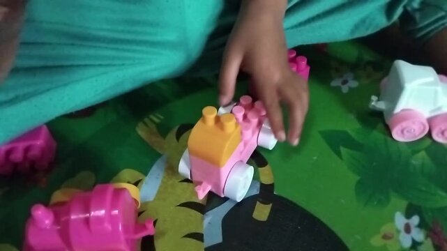 Close-up of a child playing puzzle on a colorful playmat, focusing on learning, creativity, and early childhood development