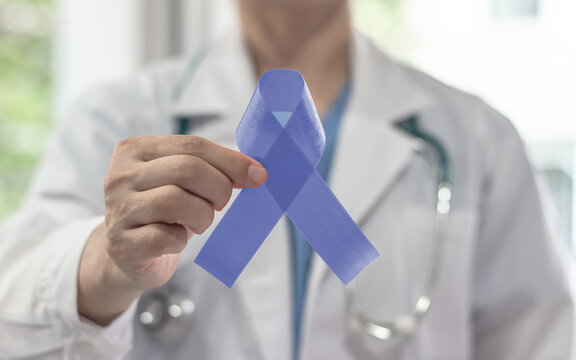 Periwinkle blue ribbon awareness with color bow on medical doctor's hand for stomach and small intestine cancer, esophageal cancer, eating disorder, Irritable Bowel Syndrome (IBS) awareness