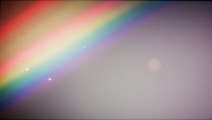 Obraz premium Celestial Spectacle: A vibrant rainbow paints the sky with its spectrum of colors, while a soft lens flare adds a touch of ethereal beauty and magic.