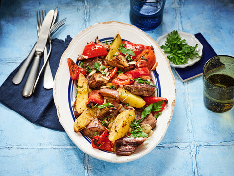 This dish features a vibrant mix of roasted vegetables and beef served on a plate. Perfect for restaurant menus, food blogs, and social media posts focused on healthy eating