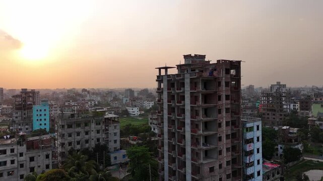 sunset over the city with underconstruction building