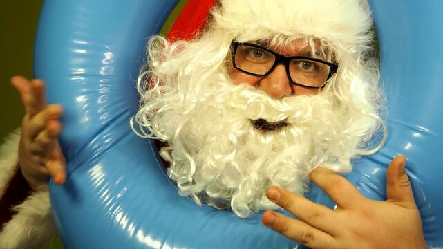 Santa Claus dreams of a seaside vacation with an inflatable ring
