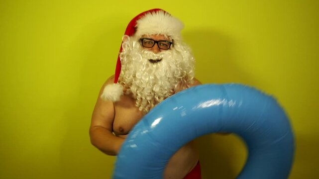 Santa Claus dreams of a seaside vacation with an inflatable ring
