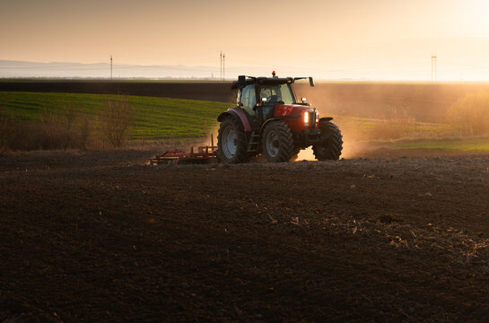 Farmer in tractor preparing land for sowing