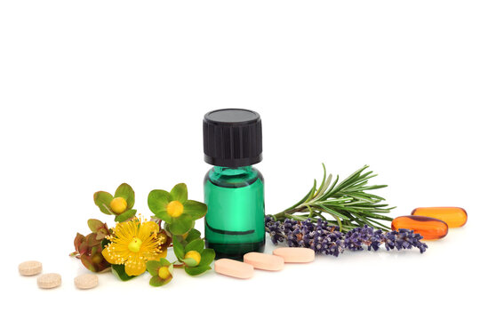Alternative herbal medicine herbs to treat depression, green tincture bottle, omega 3 capsules, vitamin D supplement tablets and St Johns Wort, rosemary, lavender herbs on white.